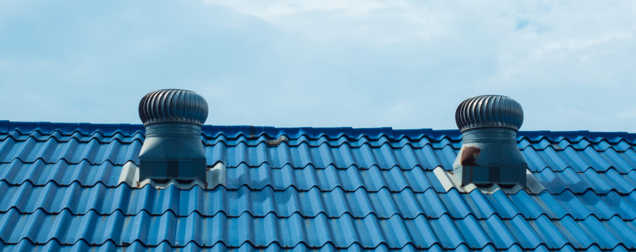 Vents on a metal shingled roof.