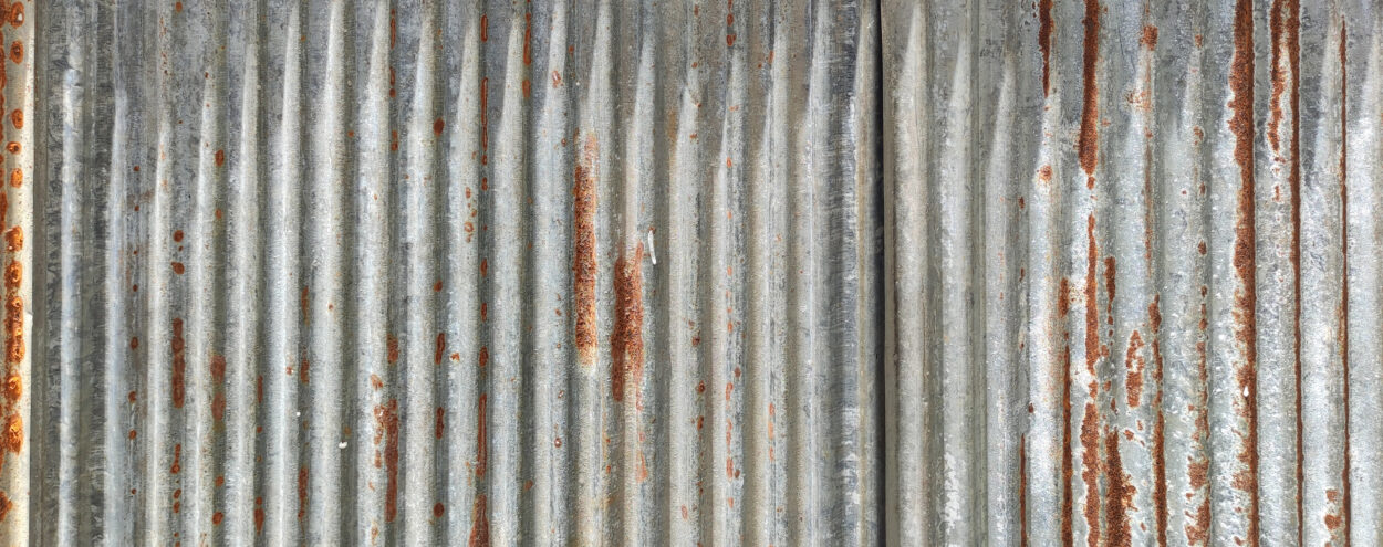 A damaged sheet of galvanized metal.