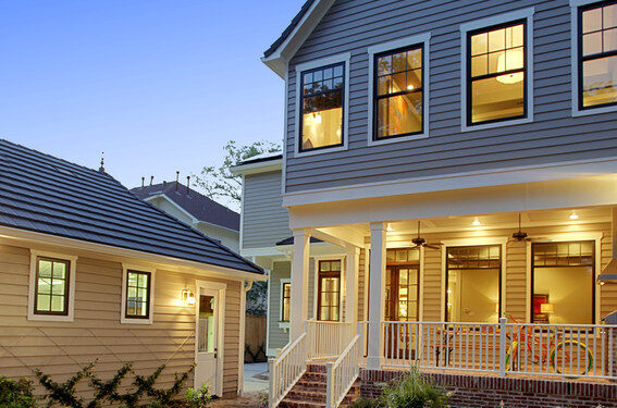 An outdoor night photo of a two-story residential home with James Hardie siding.